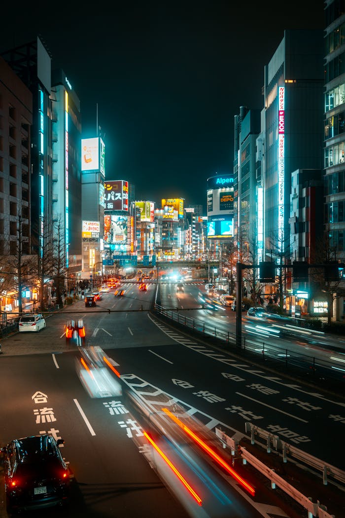 Vibrant cityscape of Tokyo's illuminated skyscrapers and busy streets at night.